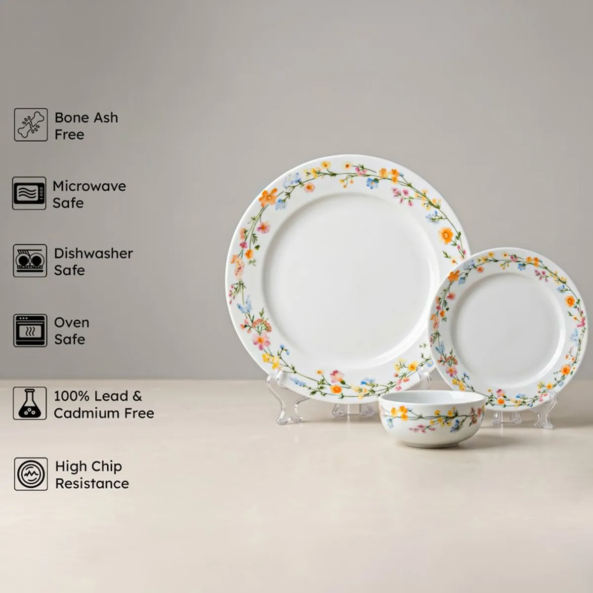 Three floral porcelain pieces displayed upright against a plain background