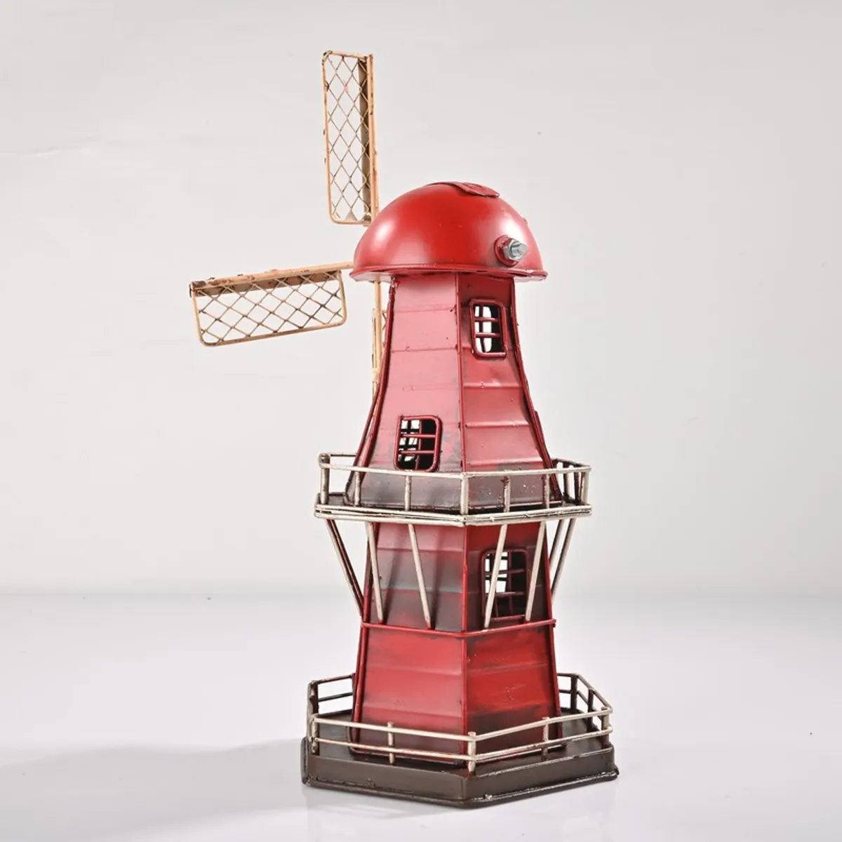 Red windmill tabletop showpiece shown against a light background