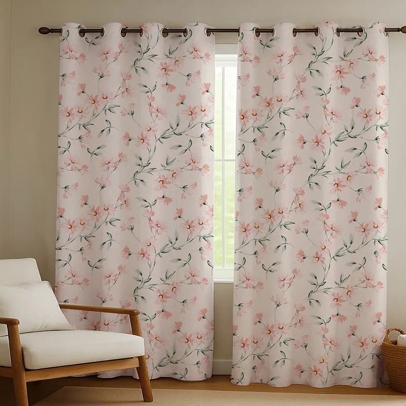 Floral curtains hanging across a window beside a lounge chair