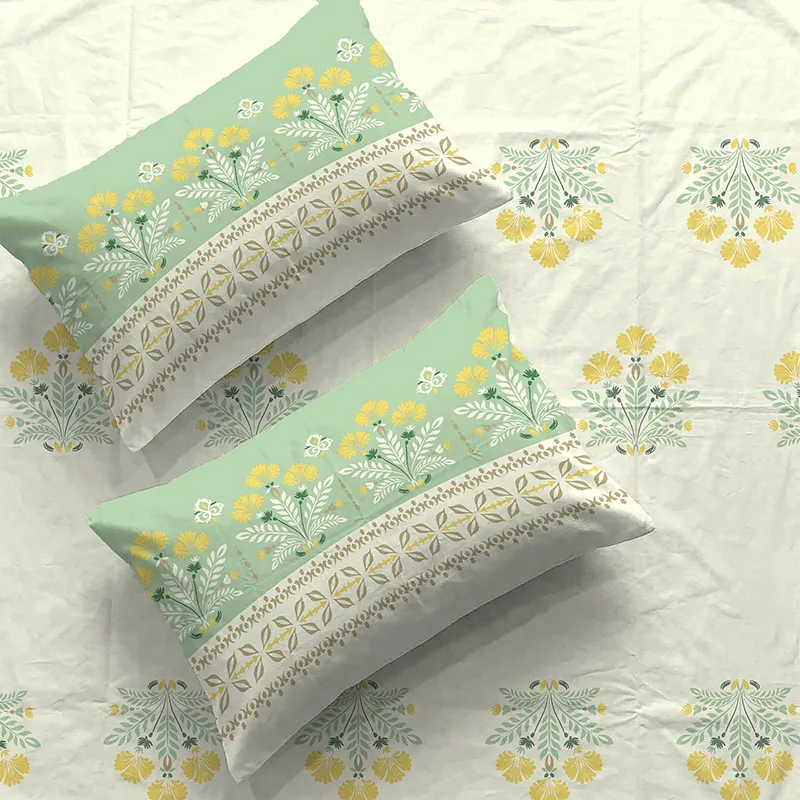 Close-up of floral printed bedsheet and matching pillow covers in off-white and green