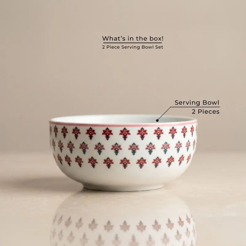 Single white serving bowl with pink floral motif on a neutral background