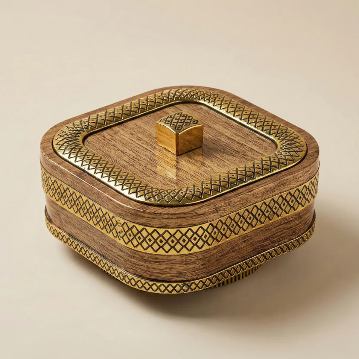 Closed brown and gold square masala box with decorative geometric detailing