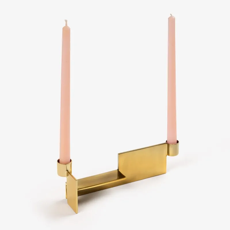 Gold dual candle holder displayed with two pink taper candles