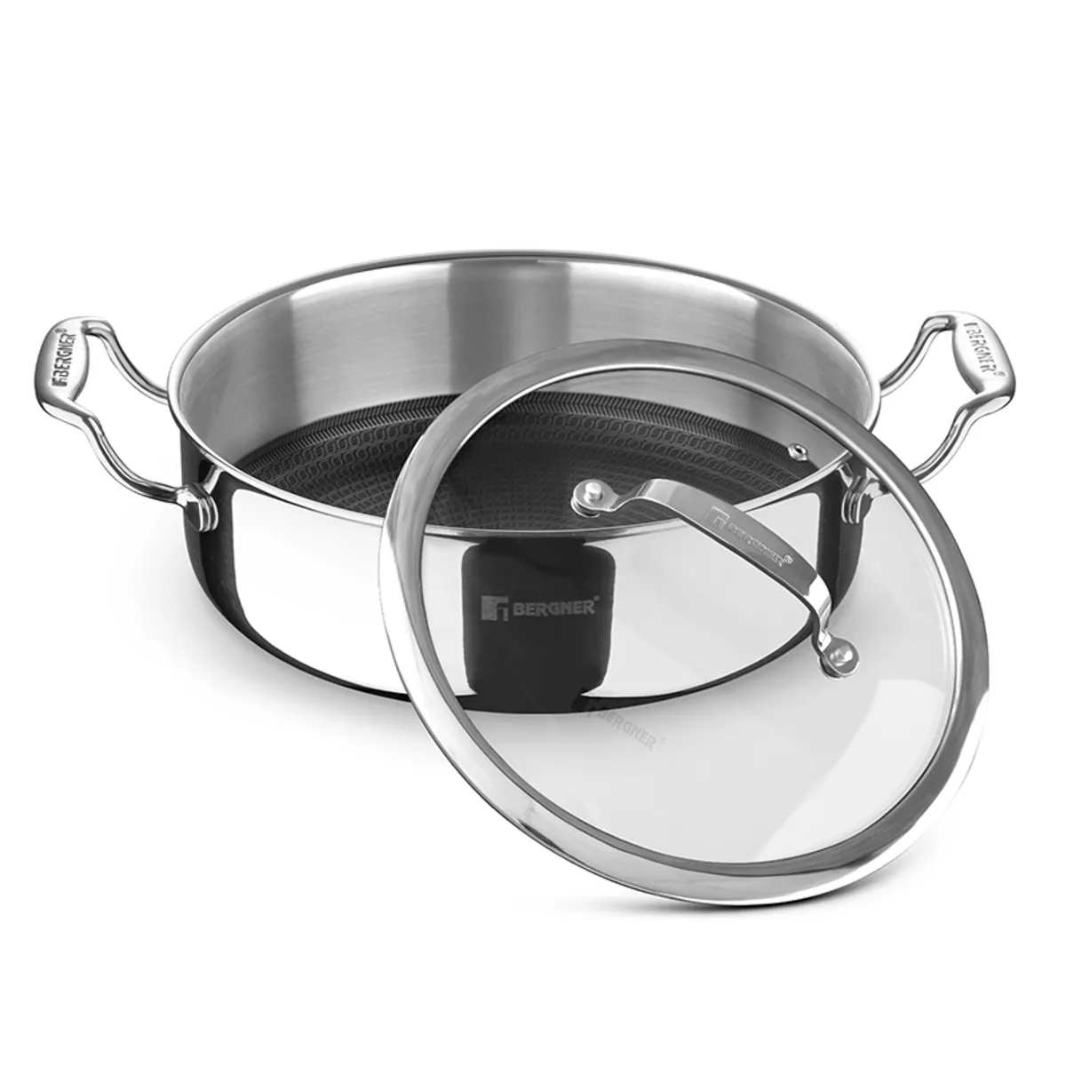Silver round cooking pot with glass lid placed beside it on a white background