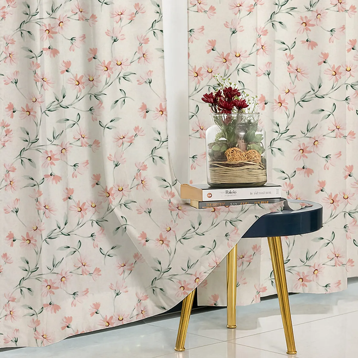 Pink floral curtain fabric draped behind a small side table