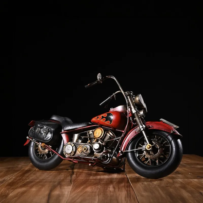 Red retro motorcycle decor piece shown against a dark background