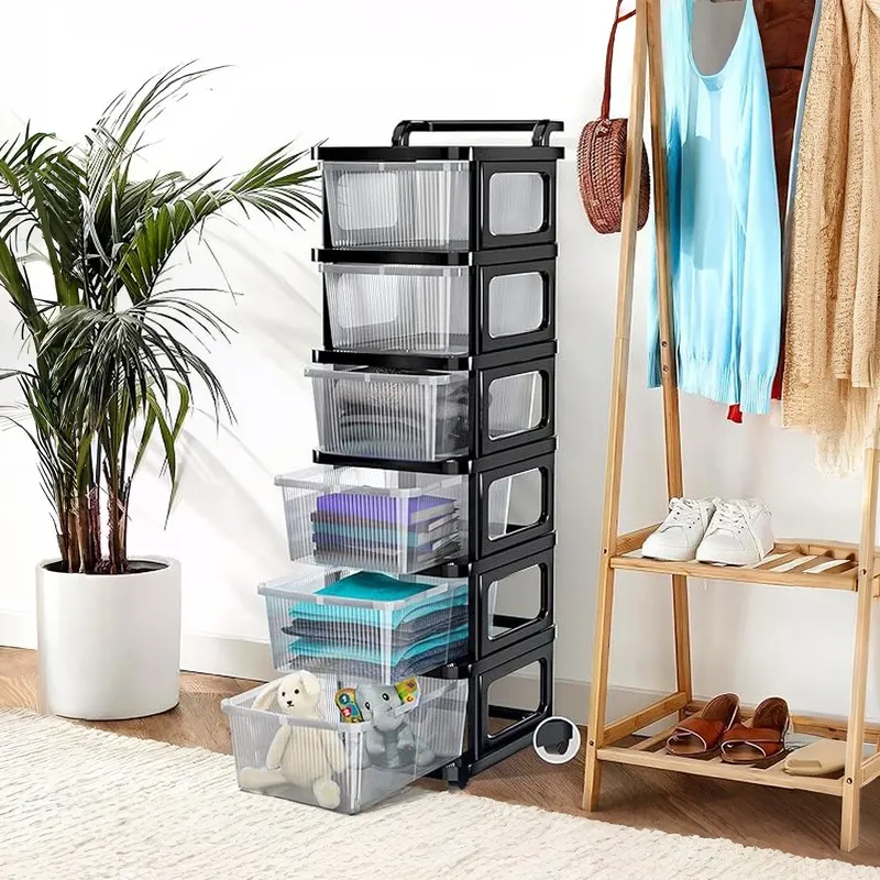 Black wheeled storage rack with open drawers in a room beside a clothes rack