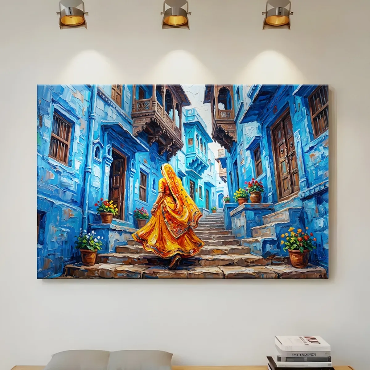 Large blue city canvas painting hung on a wall under spotlights