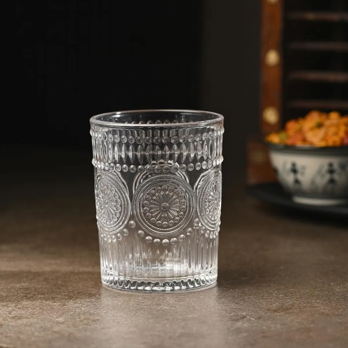 Single clear whiskey glass with embossed textured pattern