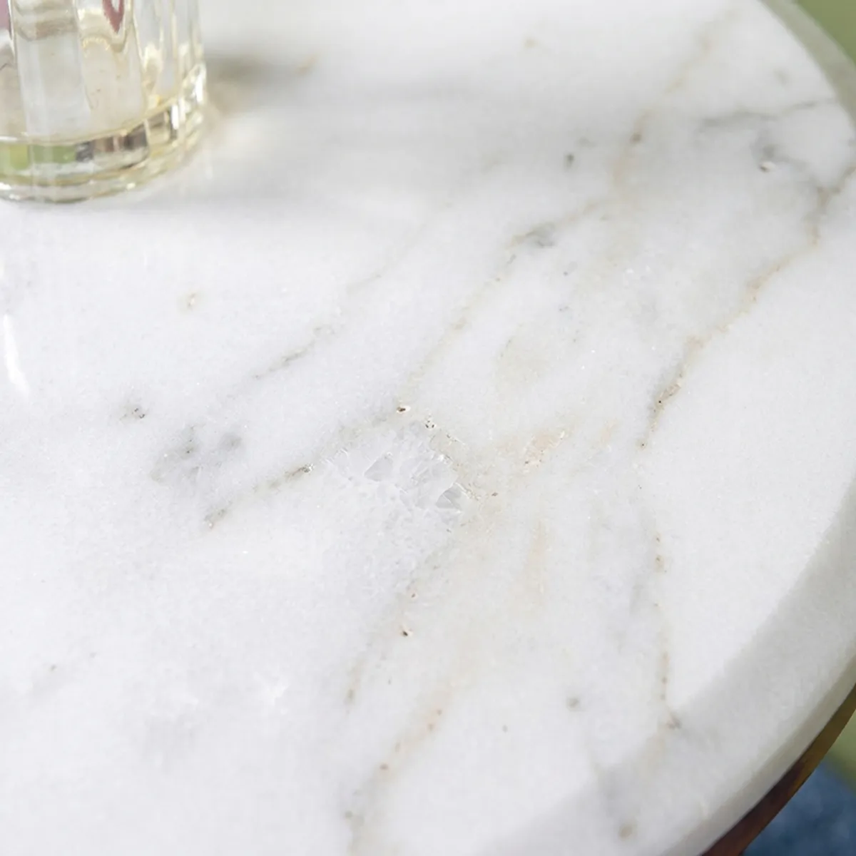 Close-up view showing the veined white marble tabletop