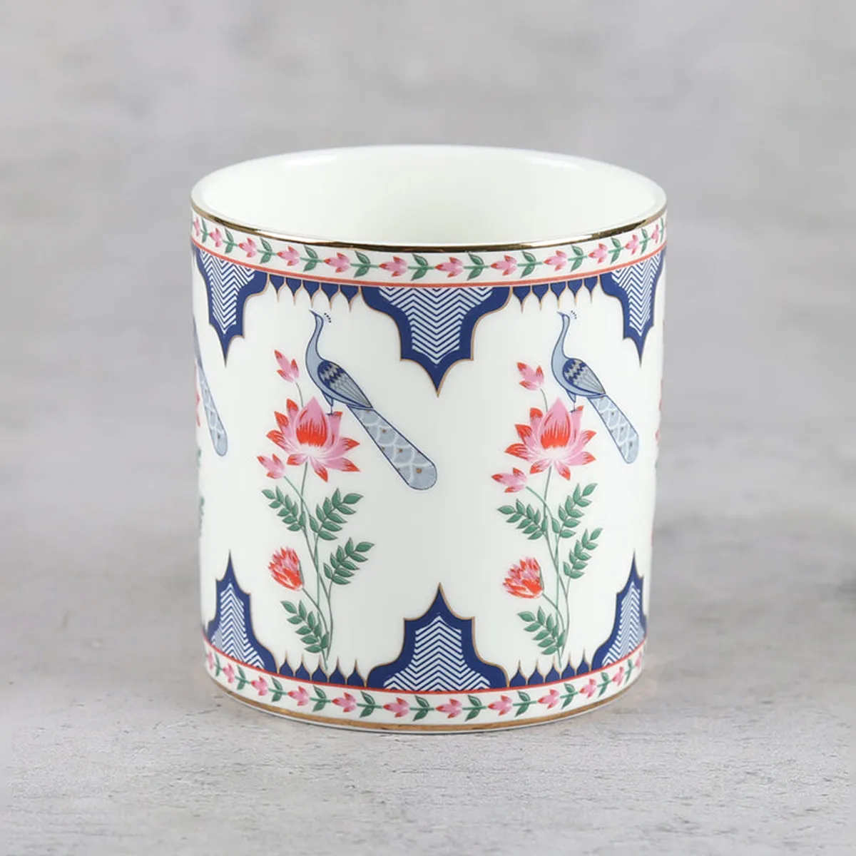 Front view of printed ivory tea cup with peacock and flowers