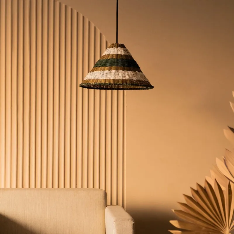 Coastal striped hanging lamp above a sofa in a softly lit room