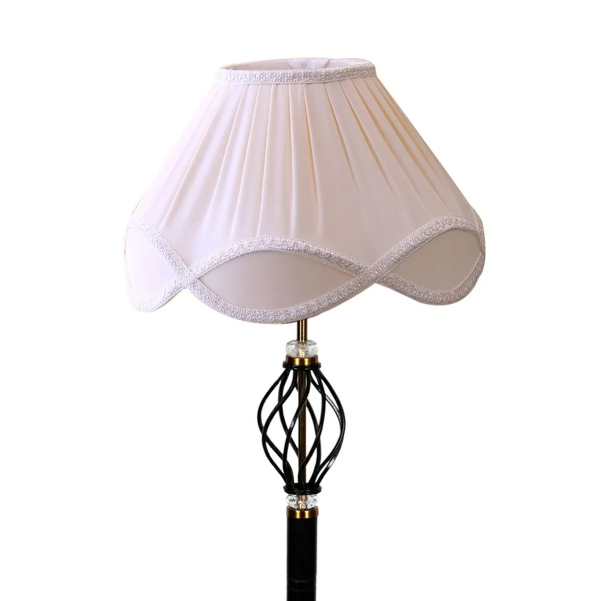 Close-up of pleated pale pink shade and decorative black lamp stem
