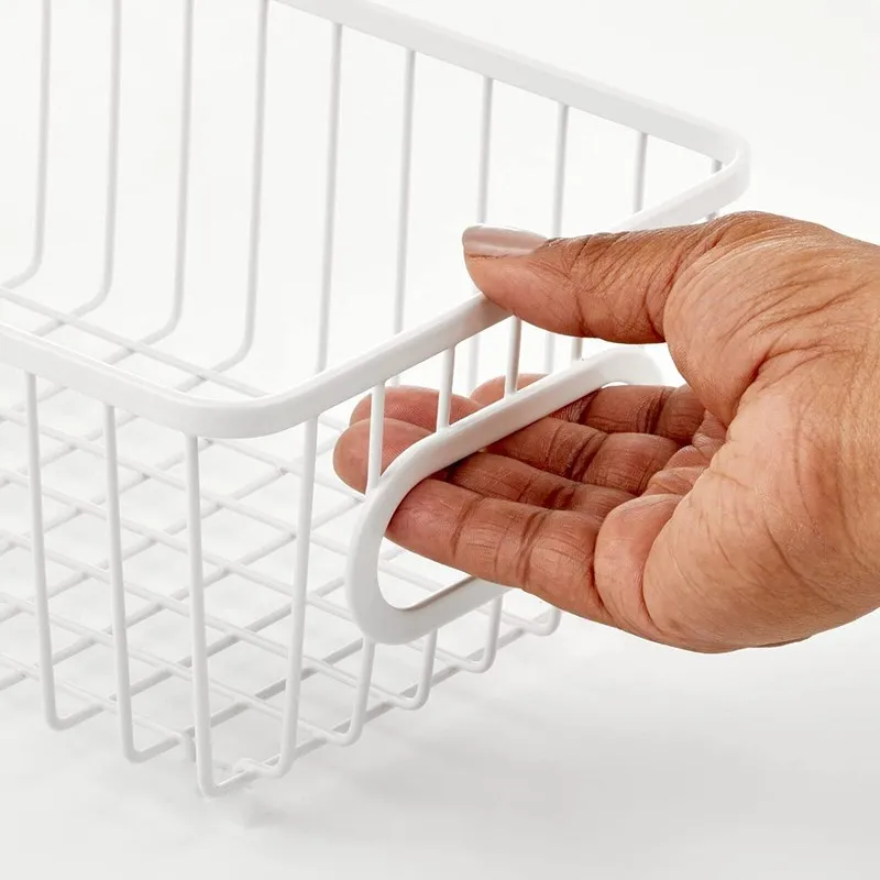Close-up of the built-in handle on a white wire storage basket