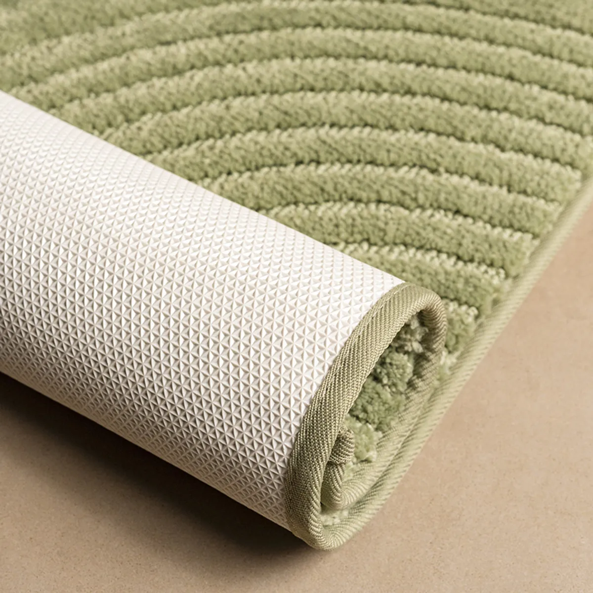 Close-up of green runner rug showing plush pile and geometric arc pattern