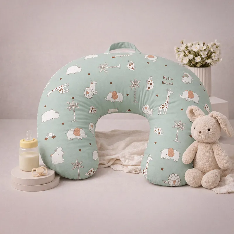 Green U-shape feeding pillow with animal print and carry handle styled beside soft toys