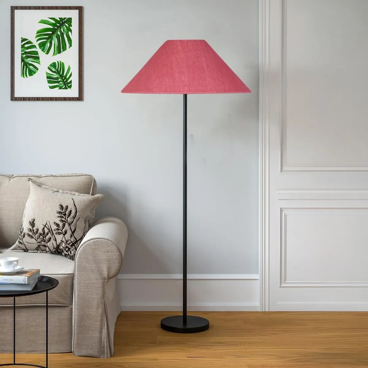 Pink floor lamp with black stand in a bright living room corner