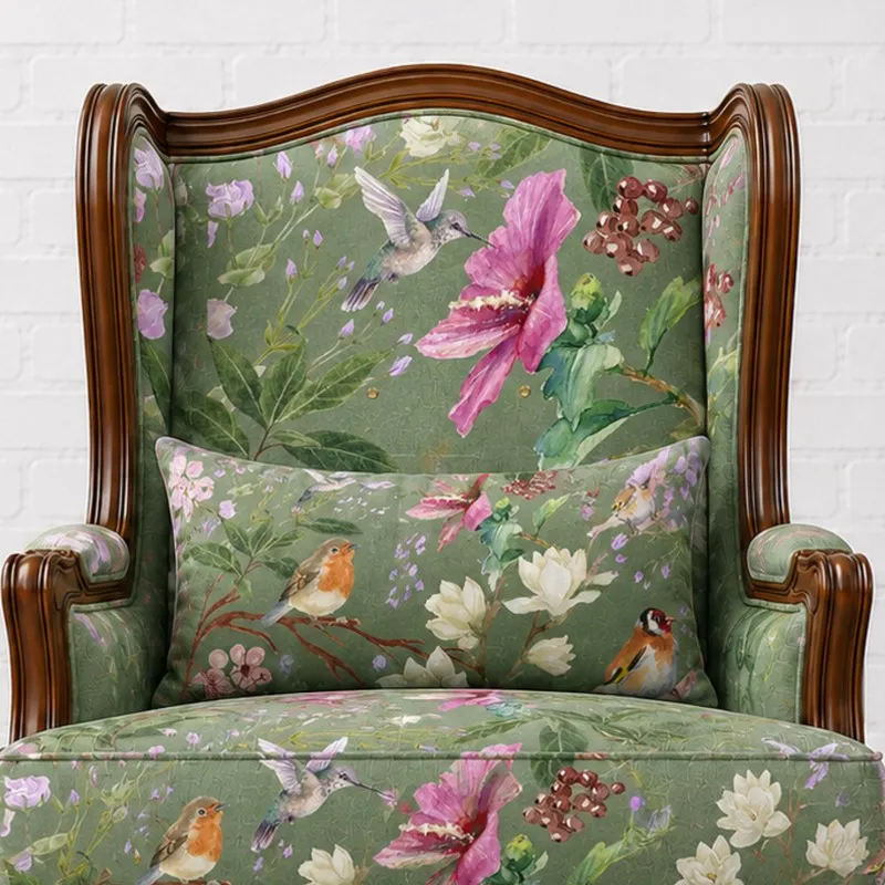 Close-up of high back lounge chair with green botanical bird upholstery