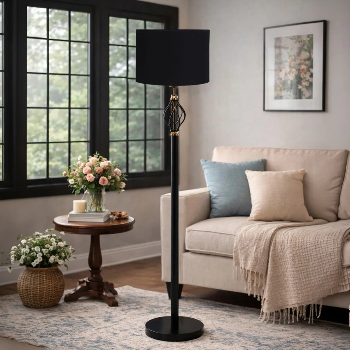 Black floor lamp with drum shade in a bright living room near a sofa
