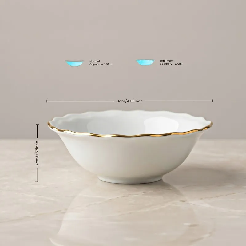 White bowl with scalloped rim and gold detailing