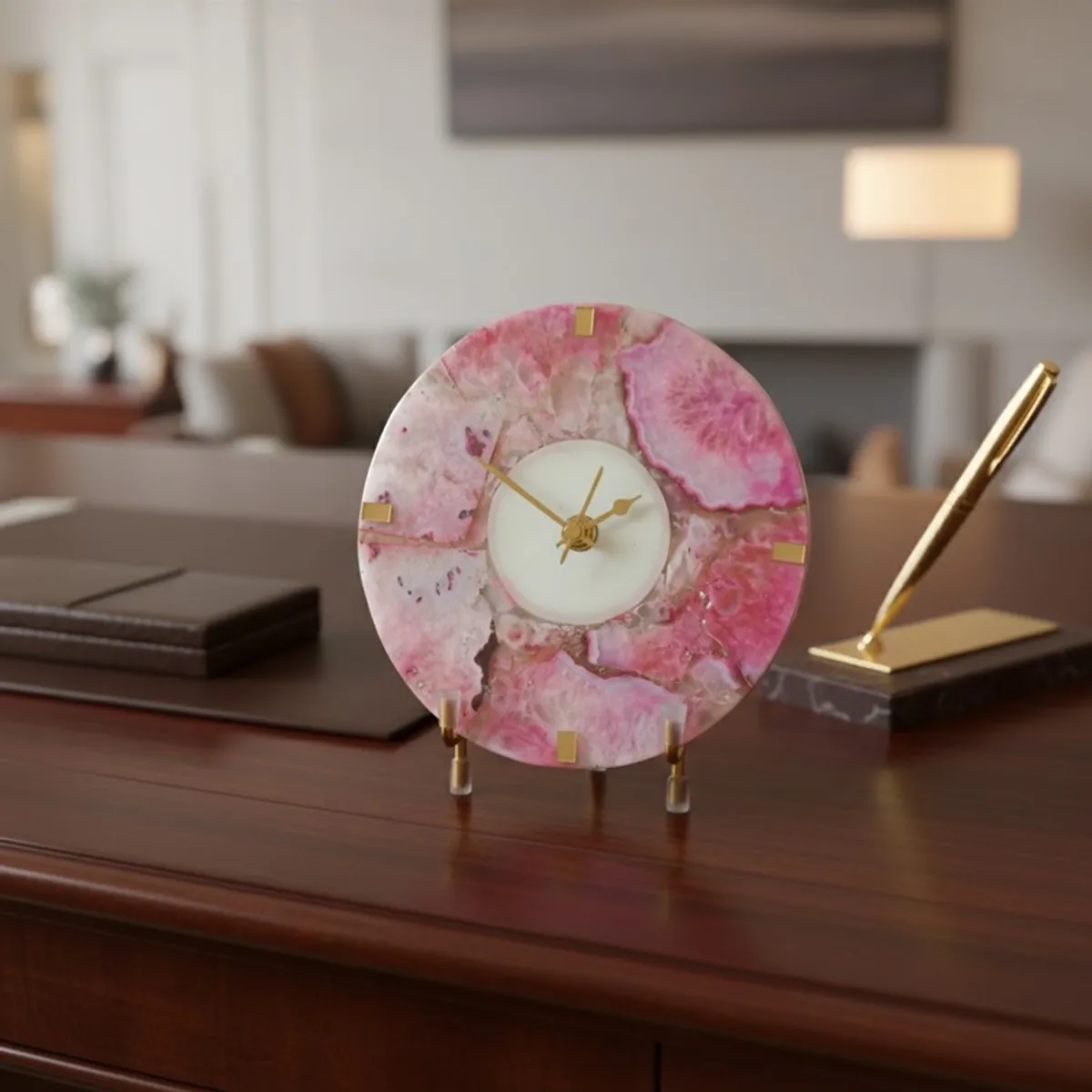 Pink agate table clock with stand styled on a wooden desk
