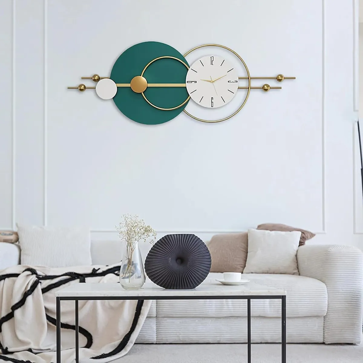 Long horizontal metal wall clock displayed above a sofa in a living room