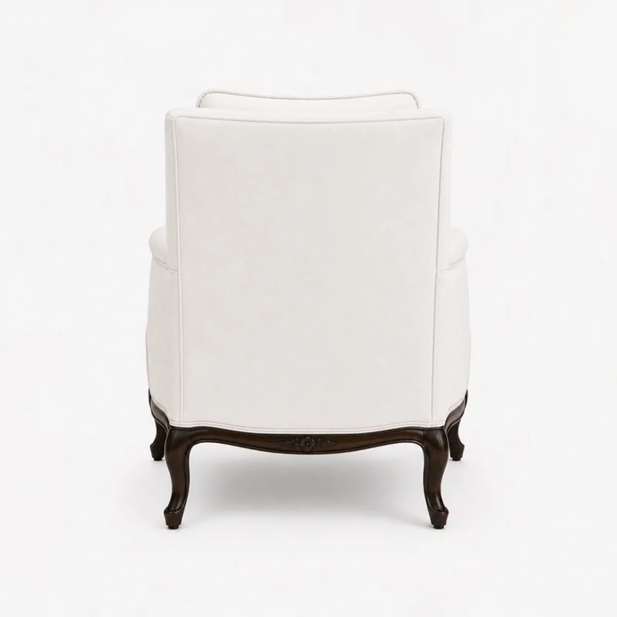 Back view of a white upholstered lounge chair with dark curved wooden legs
