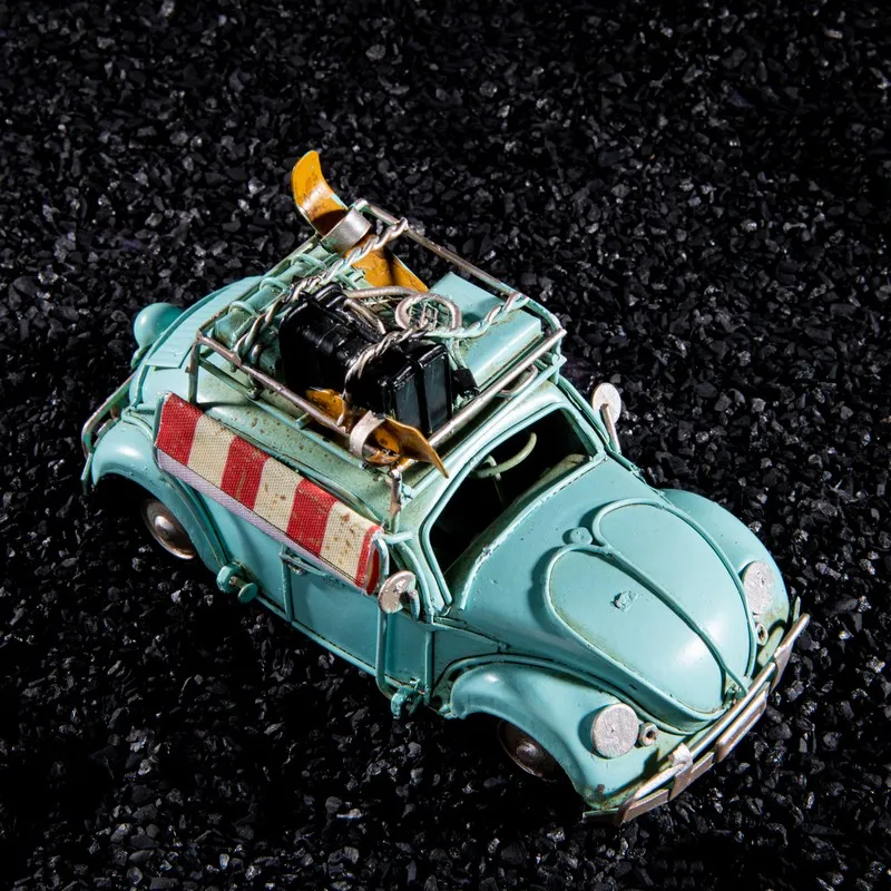 Top angled view of retro beach car showpiece with surfboard and lifebuoy