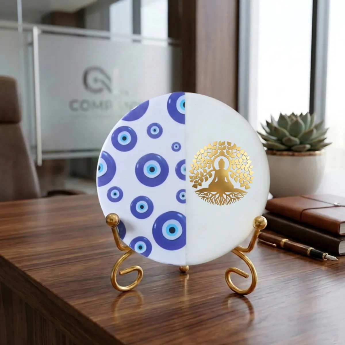 Round blue and white marble showpiece on a gold stand placed on a wooden desk.