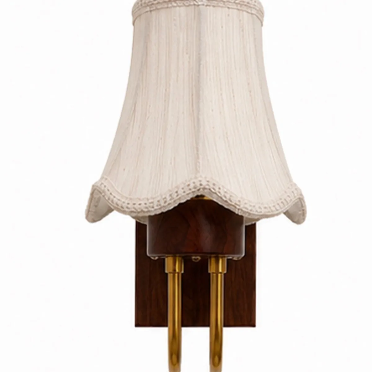 Close view of the white scalloped cotton shade and wood-and-gold wall lamp