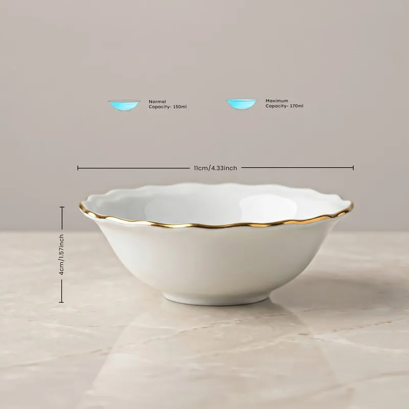 White porcelain bowl with scalloped rim and gold edge