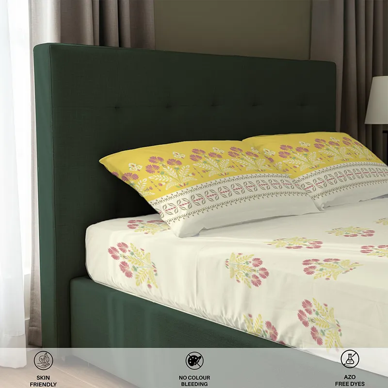 Side close-up of floral fitted bedsheet and matching pillow covers on a bed