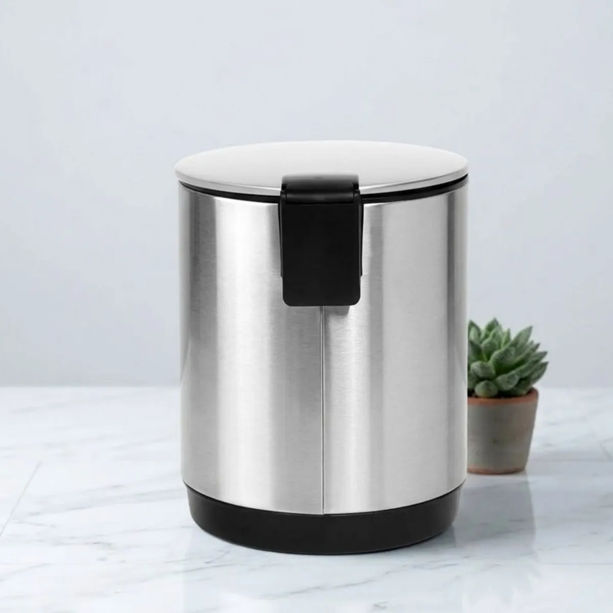 Rear view of silver cylindrical dustbin with black back pedal detail