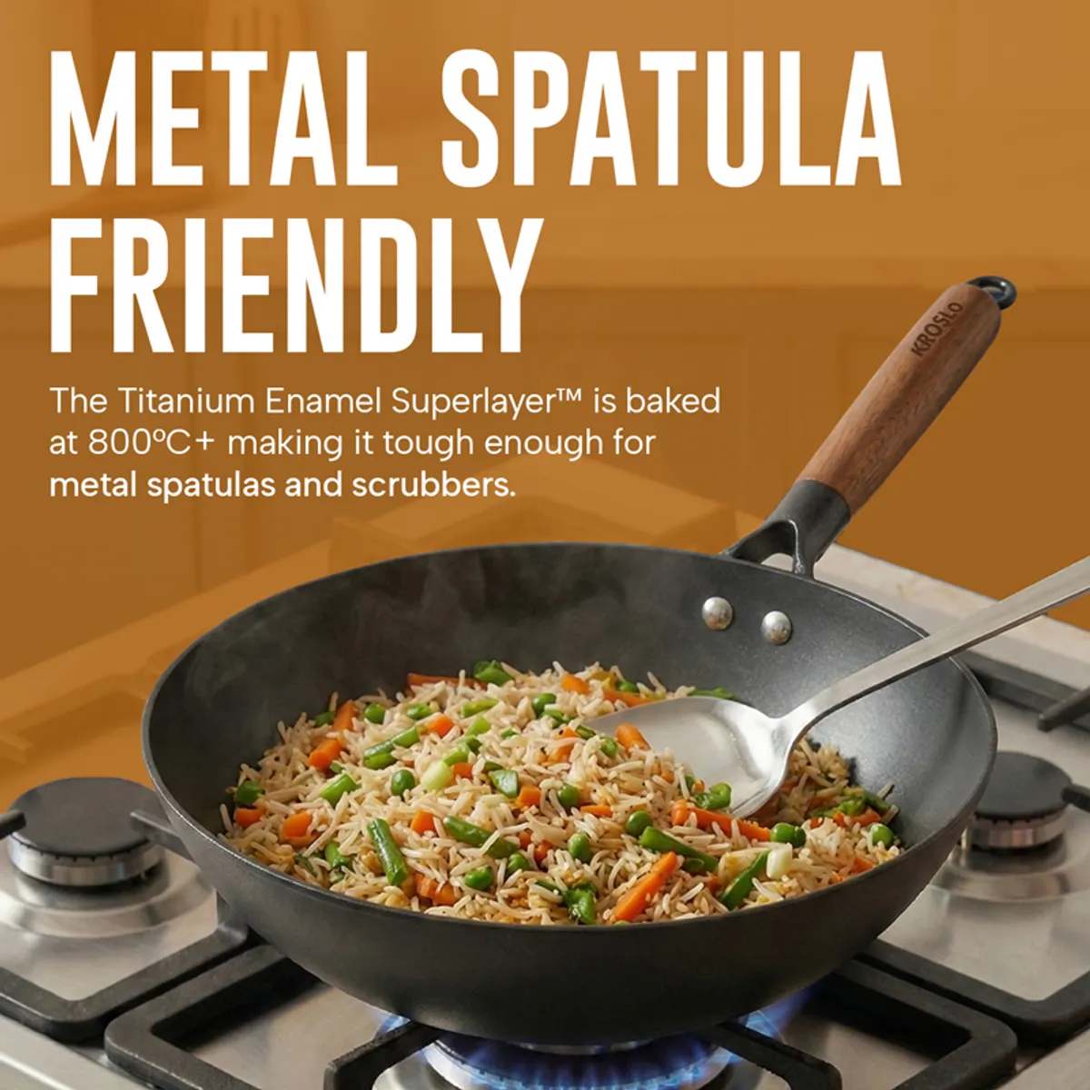 Black frying pan with rice and vegetables and a metal spatula