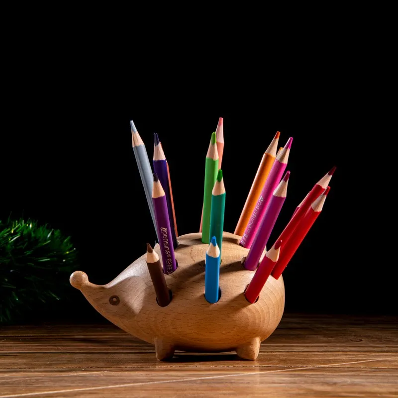 Side view of wooden hedgehog desk organiser with pencils