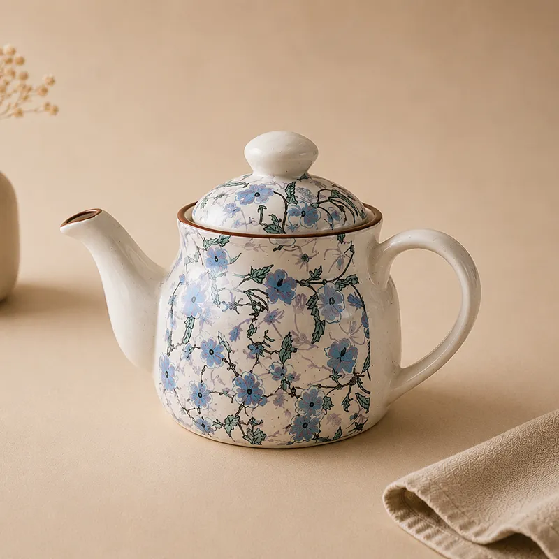 Close-up of the blue floral ceramic teapot with lid and handle