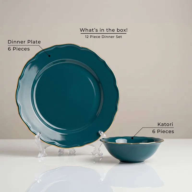 Dark teal plate and bowl with gold rim displayed on stands