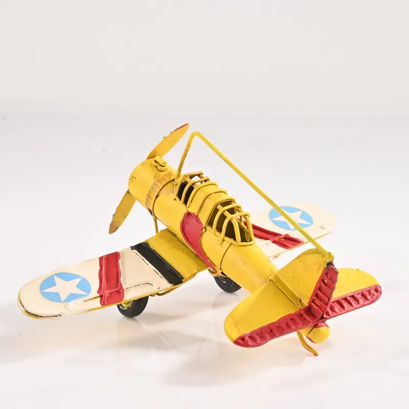 Rear angled view of the yellow airplane showpiece on a white background