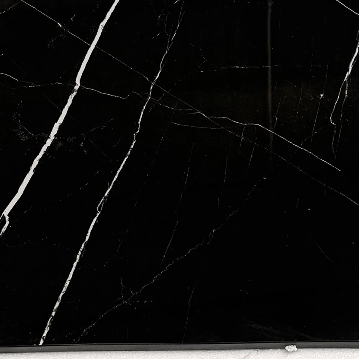 Close-up of black marble surface with white veining