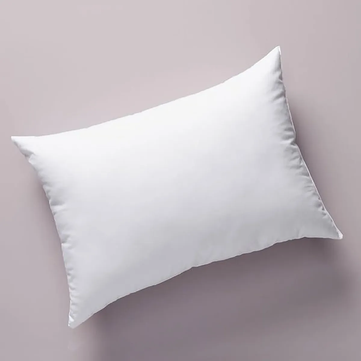 White rectangular pillow filler photographed from above on a neutral background.