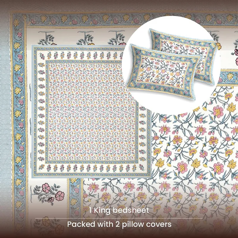 Top view of floral bedsheet and two matching pillow covers with blue border