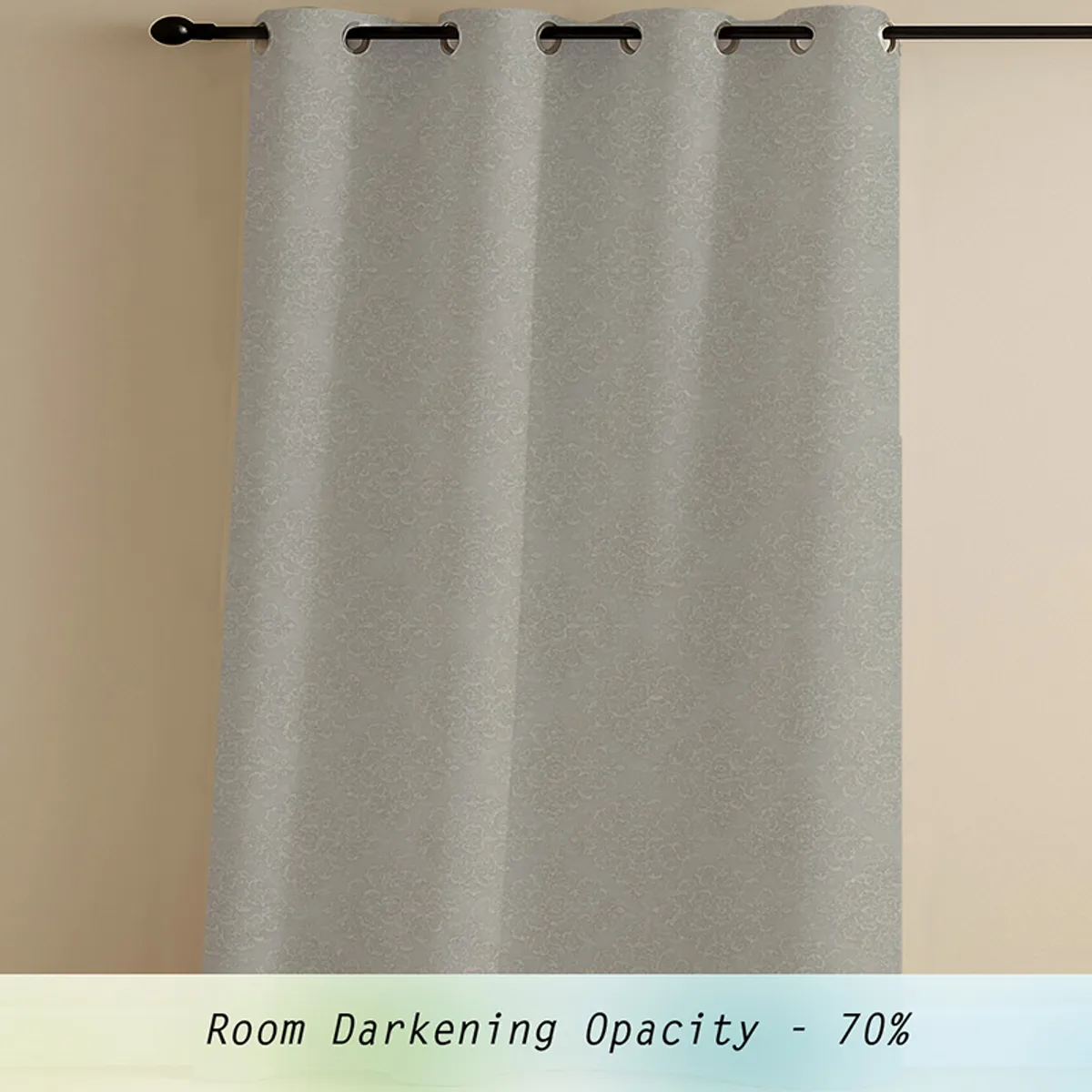 Single grey patterned eyelet curtain hanging on a rod