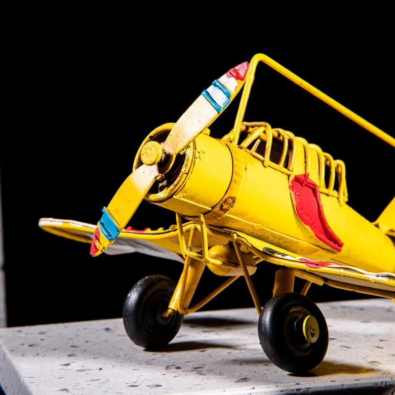 Front-side close-up of the yellow airplane showpiece