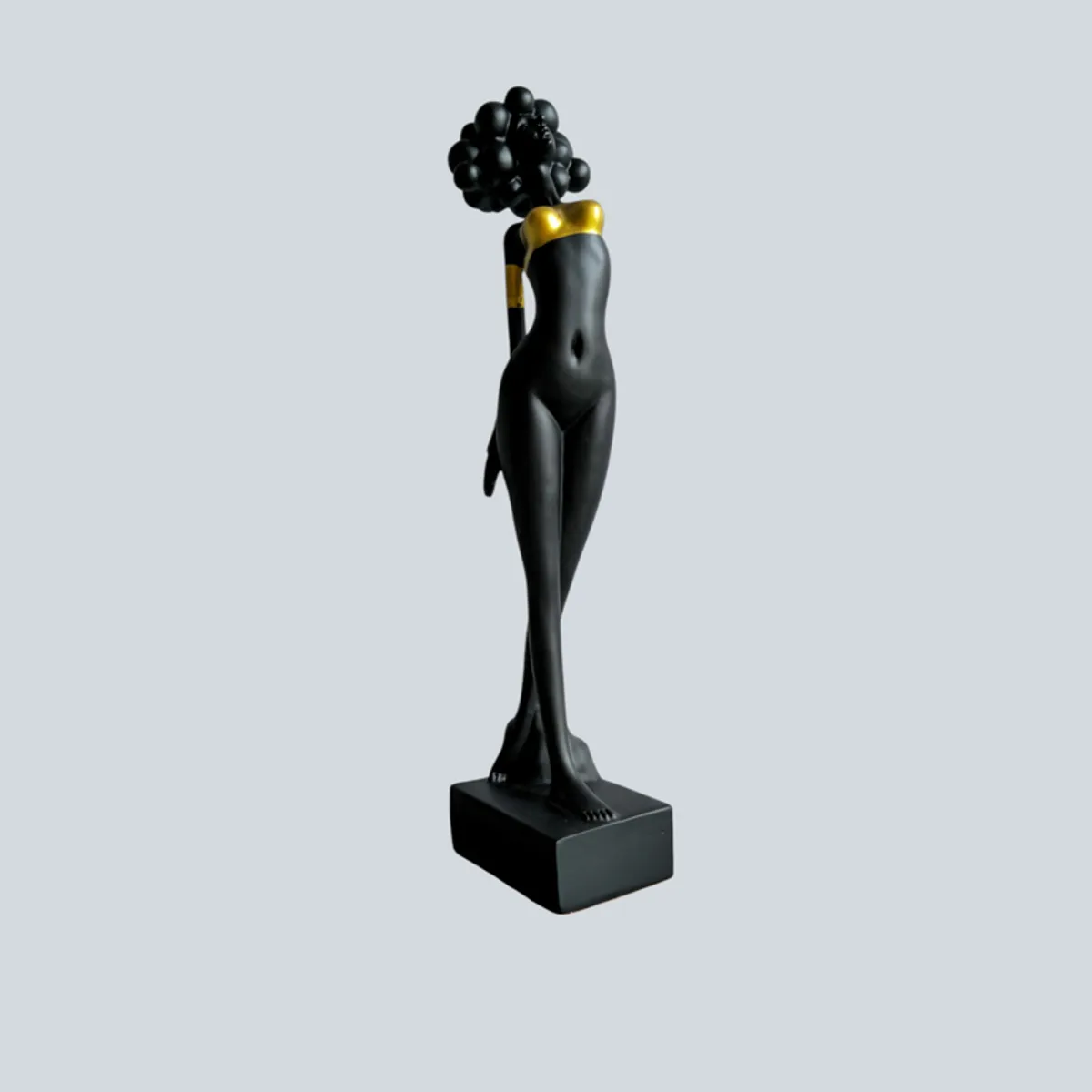 Front view of a black and gold lady figurine on a rectangular base