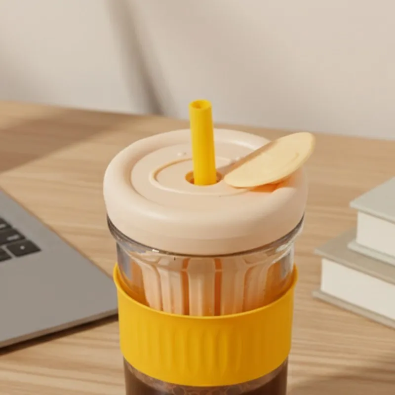 Close view of orange grip glass tumbler with lid and infuser