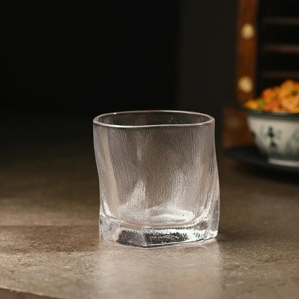Single clear whiskey glass with a softly textured surface