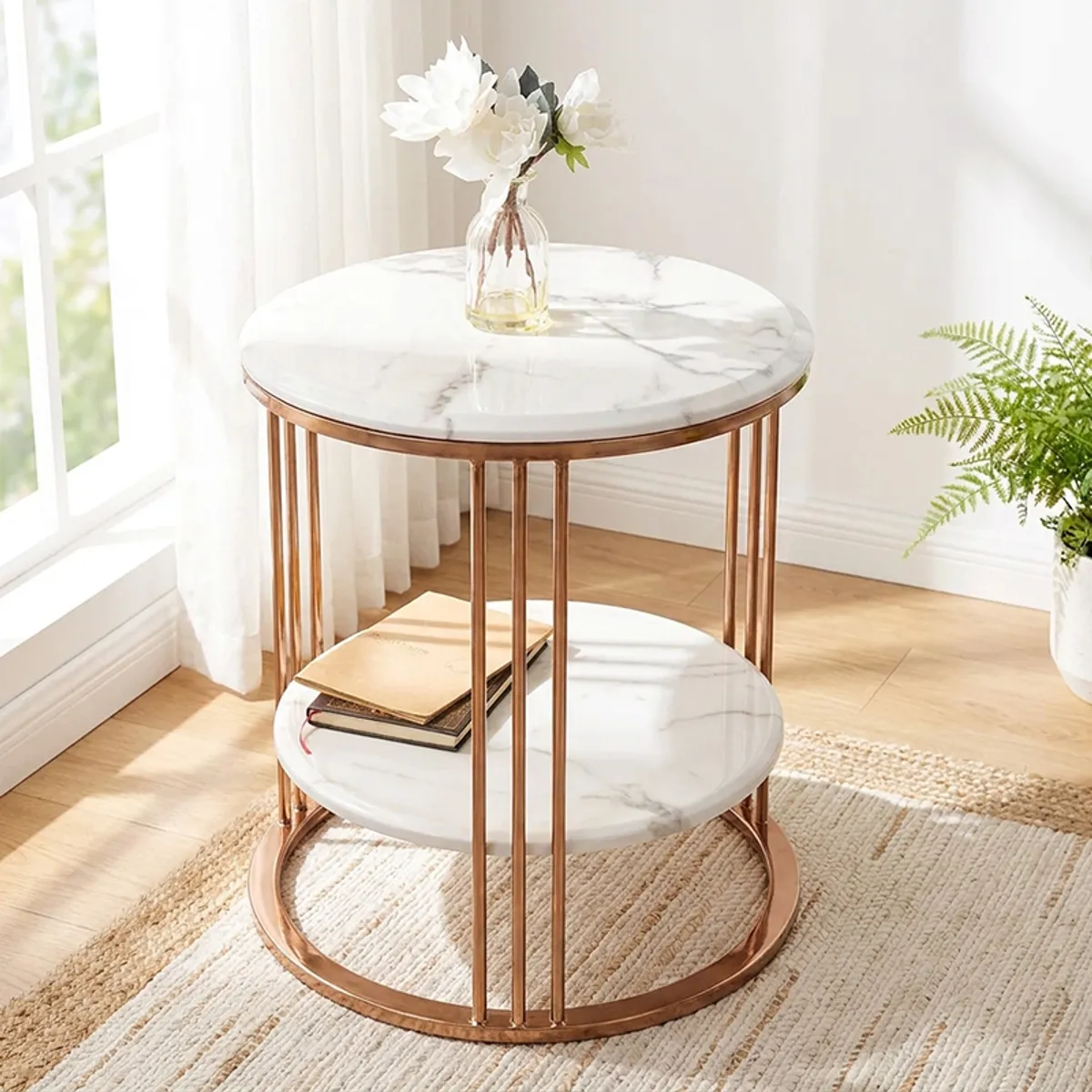 White and gold side table styled beside a window with books and flowers