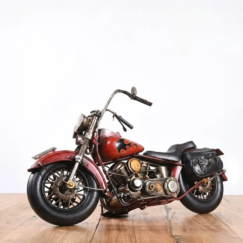 Red iron motorcycle showpiece displayed on a wooden surface