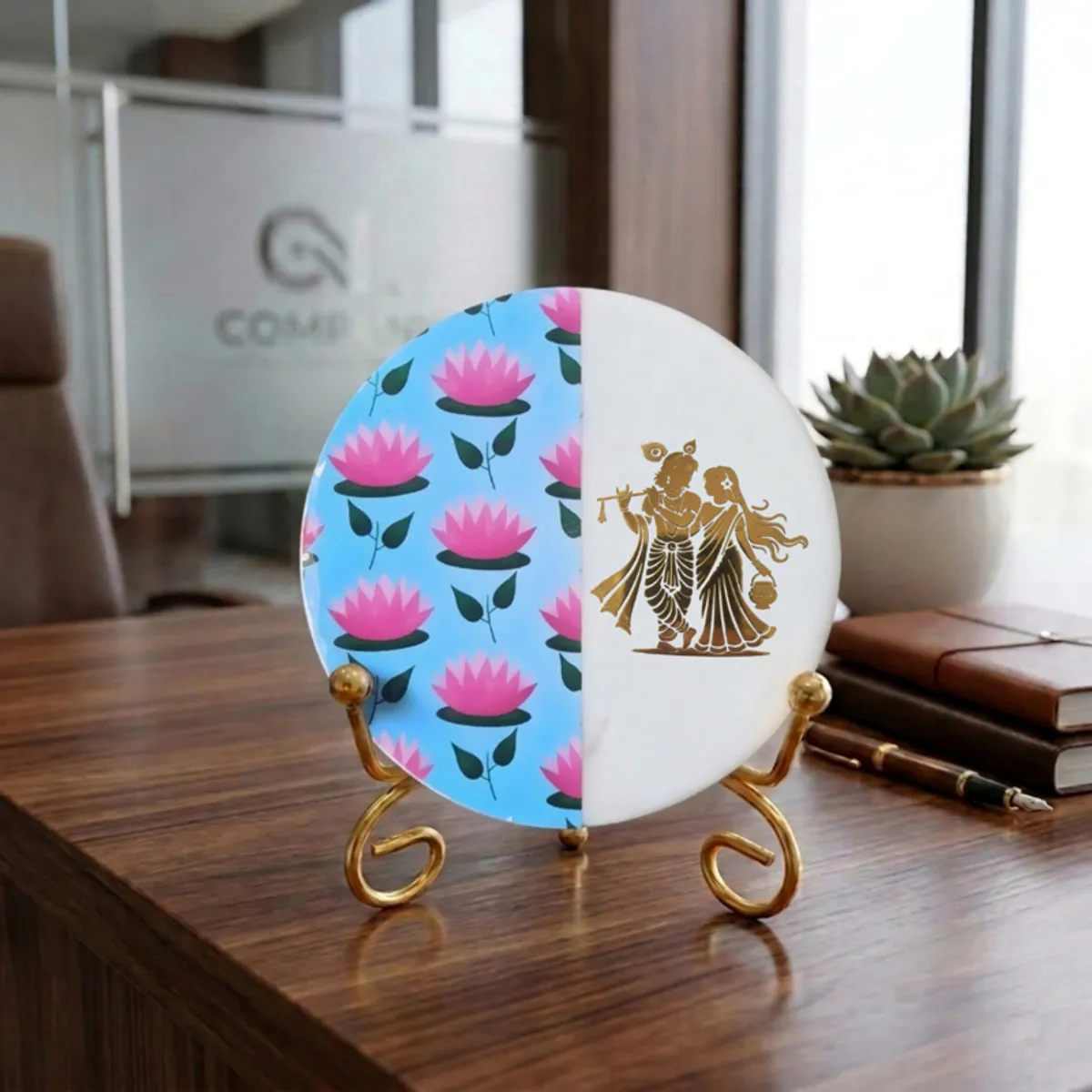 Round marble showpiece with lotus pattern and gold stand on a wooden desk