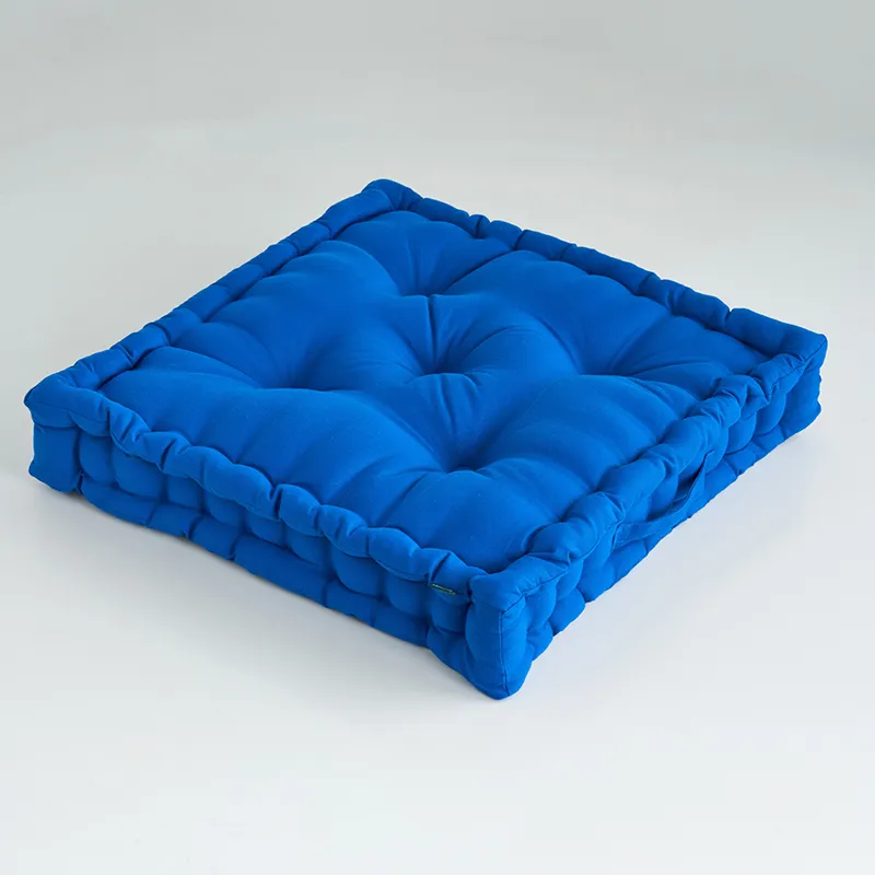 Single classic blue square floor cushion on a plain white background